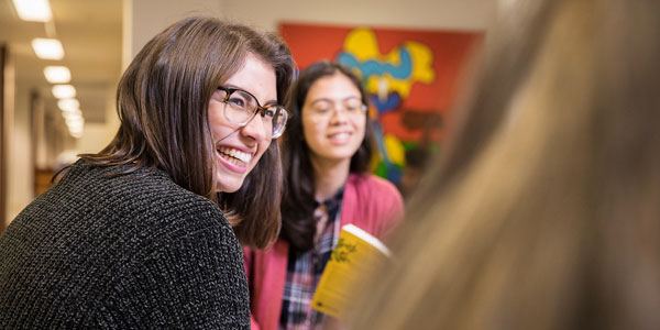 Student smiling in conversation